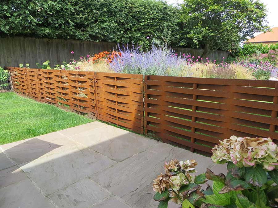 woven steel fencing and wooden gate